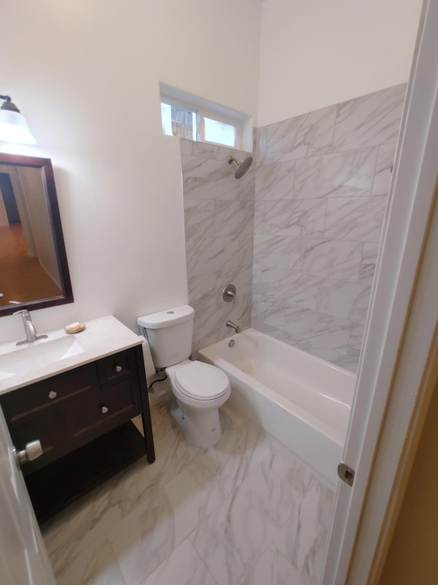 full bathroom with vanity, tiled shower / bath combo, and toilet