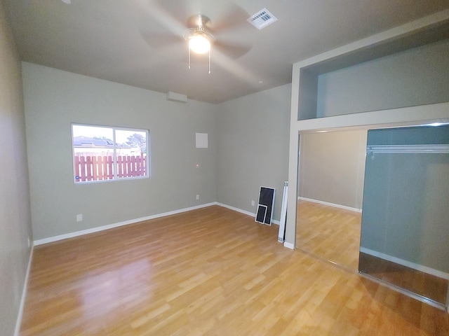 unfurnished bedroom featuring wood-type flooring, a closet, and ceiling fan