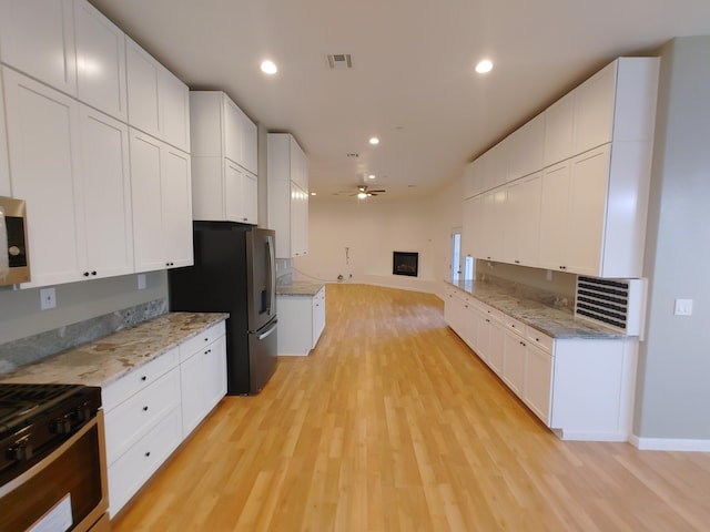 kitchen featuring appliances with stainless steel finishes and white cabinets