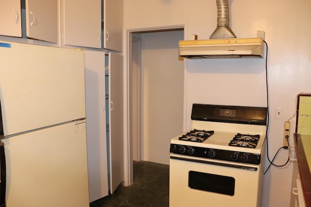 kitchen featuring white appliances and range hood