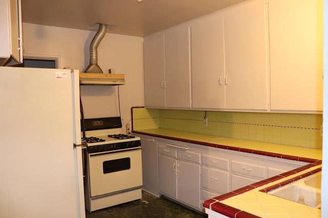 kitchen with tile countertops, white cabinetry, sink, decorative backsplash, and white appliances