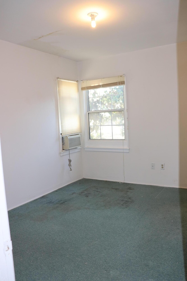 carpeted spare room with cooling unit