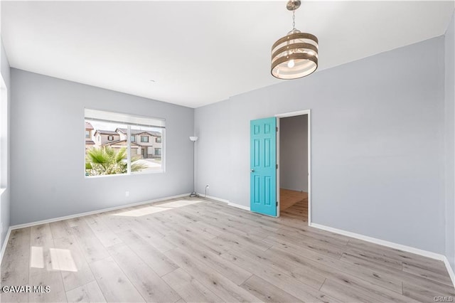 2436 Lugar Bonito Ct, Rosamond, CA 93560 - unfurnished room featuring a chandelier and wood finished floors