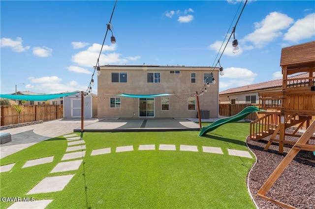 2436 Lugar Bonito Ct, Rosamond, CA 93560 - rear view of house with a shed, a fenced backyard, a playground, a patio area, and stucco siding