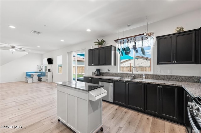 2436 Lugar Bonito Ct, Rosamond, CA 93560 - kitchen with stainless steel appliances, dark cabinetry, light wood-type flooring, and recessed lighting