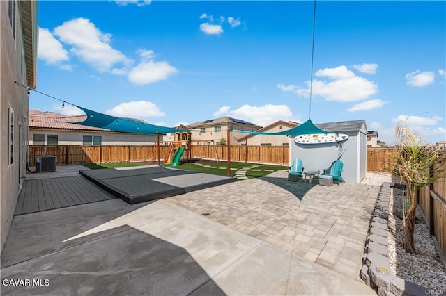 2436 Lugar Bonito Ct, Rosamond, CA 93560 - fenced backyard with a playground, a patio area, and a deck