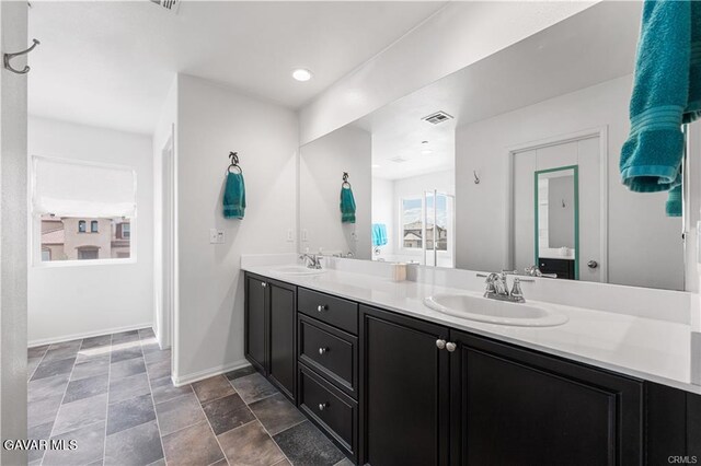 2436 Lugar Bonito Ct, Rosamond, CA 93560 - bathroom featuring double vanity and baseboards