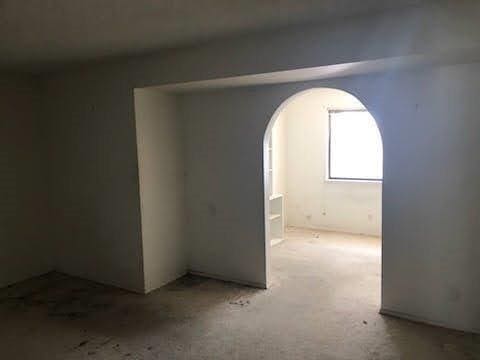 964 Roosevelt St, Ridgecrest, CA 93555 - empty room featuring arched walkways and carpet floors