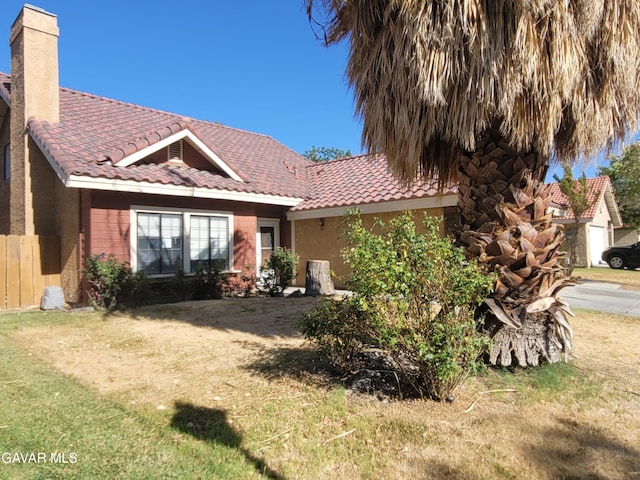 964 Roosevelt St, Ridgecrest, CA 93555 - view of front of property with a tile roof, a chimney, and stucco siding