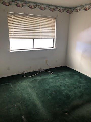 964 Roosevelt St, Ridgecrest, CA 93555 - empty room featuring dark colored carpet
