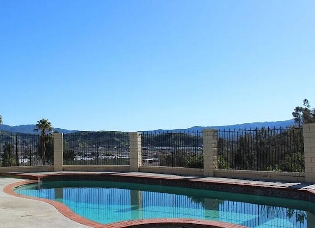 view of pool featuring a patio area and a mountain view