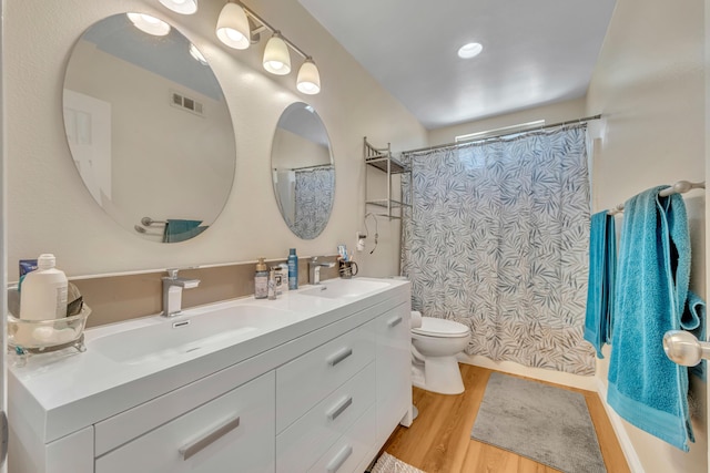38360 Wakefield Pl, Palmdale, CA 93551 - bathroom with double vanity, toilet, wood finished floors, and curtained shower