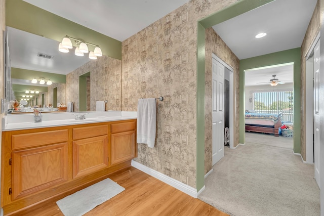 38360 Wakefield Pl, Palmdale, CA 93551 - bathroom featuring baseboards, vanity, wallpapered walls, ensuite bathroom, and wood finished floors