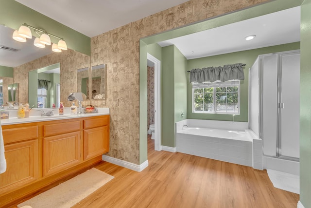 38360 Wakefield Pl, Palmdale, CA 93551 - bathroom featuring wood finished floors, wallpapered walls, a garden tub, vanity, and baseboards