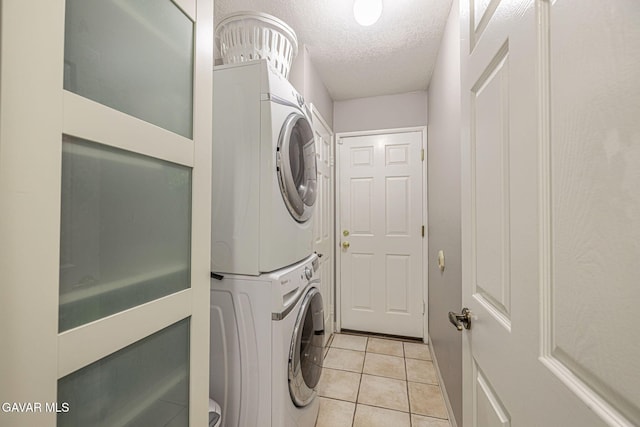 6015 Country Ln, Quartz Hill, CA 93536 - laundry room with estacked washer and dryer, a textured ceiling, and light tile patterned flooring