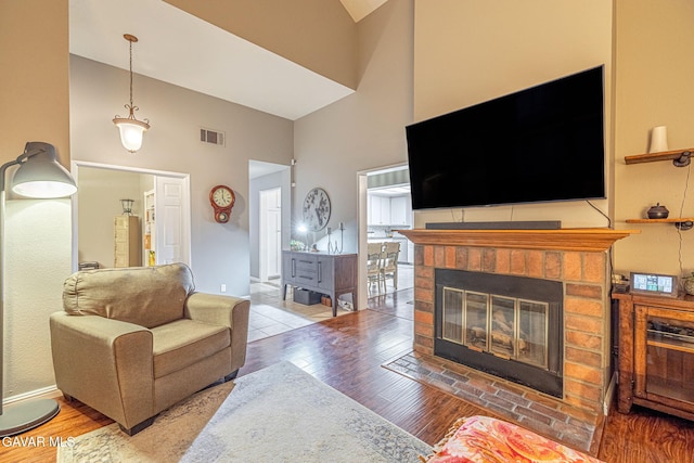 6015 Country Ln, Quartz Hill, CA 93536 - living area with a high ceiling, a brick fireplace, and wood finished floors