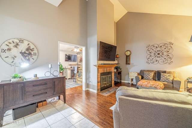 6015 Country Ln, Quartz Hill, CA 93536 - living area with high vaulted ceiling, a brick fireplace, a ceiling fan, and light wood-type flooring