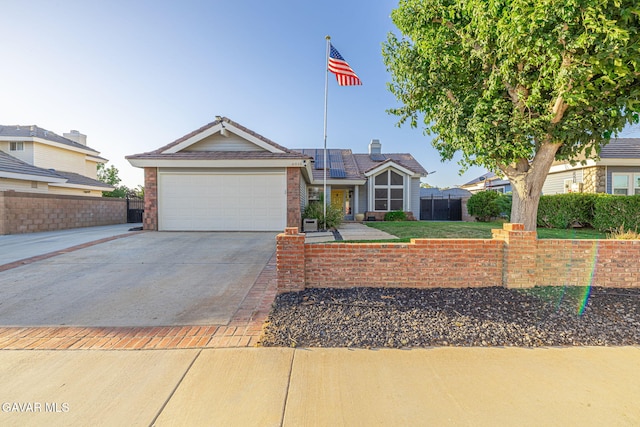 6015 Country Ln, Quartz Hill, CA 93536 - view of front facade with roof mounted solar panels, concrete driveway, and an attached garage