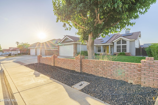 6015 Country Ln, Quartz Hill, CA 93536 - view of front of home featuring driveway, roof mounted solar panels, and a garage