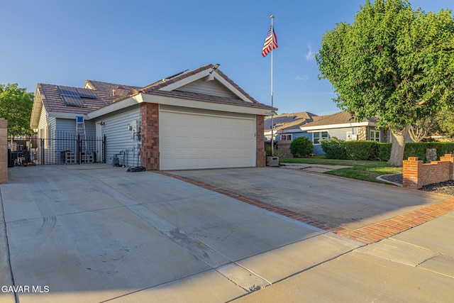 6015 Country Ln, Quartz Hill, CA 93536 - single story home with driveway, roof mounted solar panels, a garage, a tile roof, and a gate