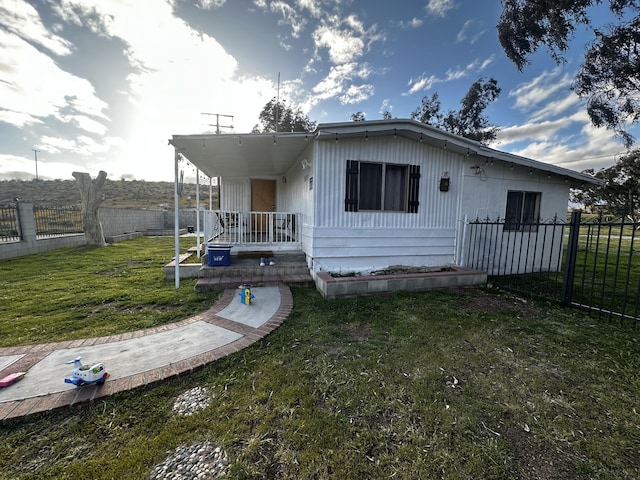 rear view of property with a lawn and covered porch