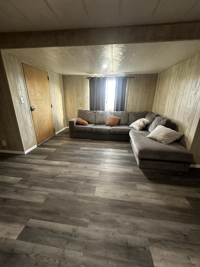 unfurnished living room with dark hardwood / wood-style floors and wood walls