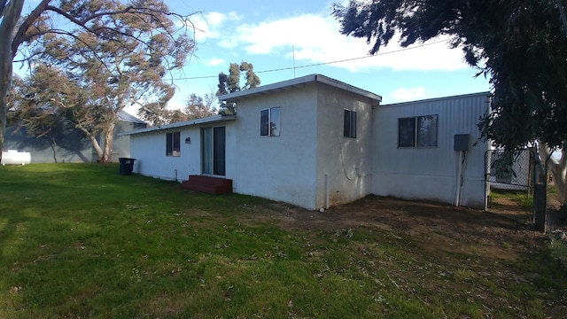 rear view of property with a yard