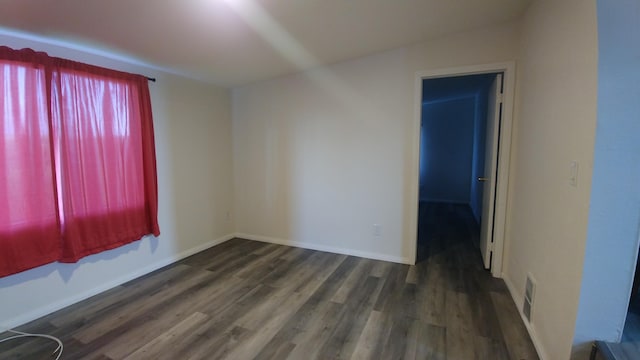 unfurnished room featuring dark hardwood / wood-style floors