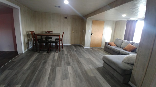 living room with wood walls and hardwood / wood-style flooring