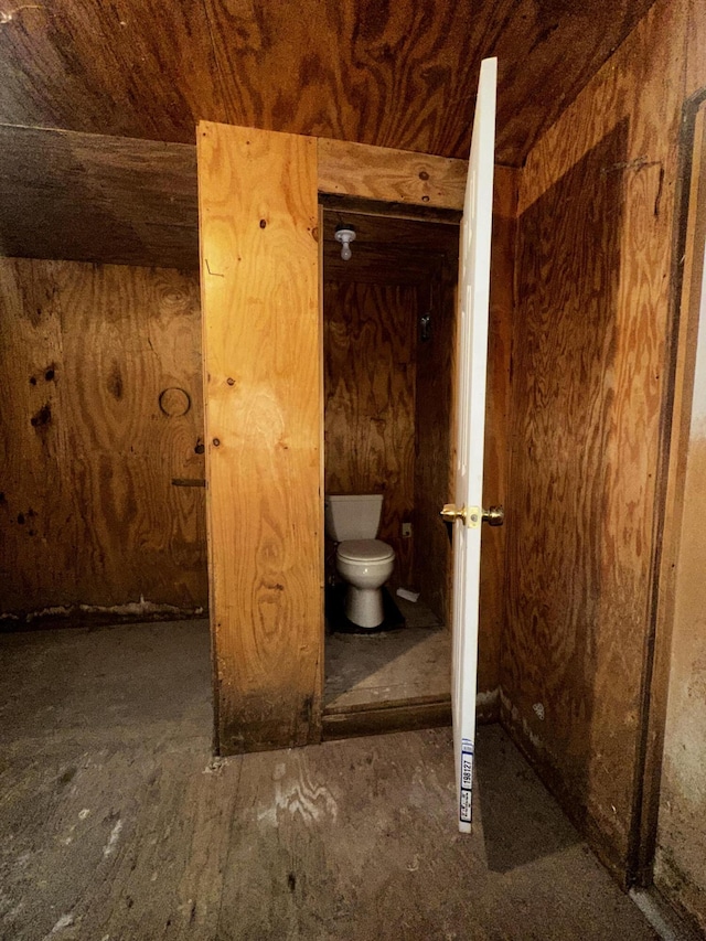 bathroom with toilet and wood ceiling