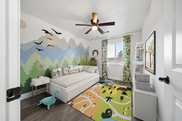 bedroom with a ceiling fan, baseboards, and wood finished floors