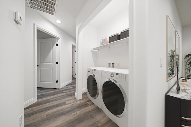 clothes washing area with visible vents, baseboards, laundry area, light wood-style floors, and independent washer and dryer