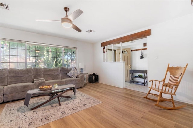 living room featuring ceiling fan and light wood-type flooring