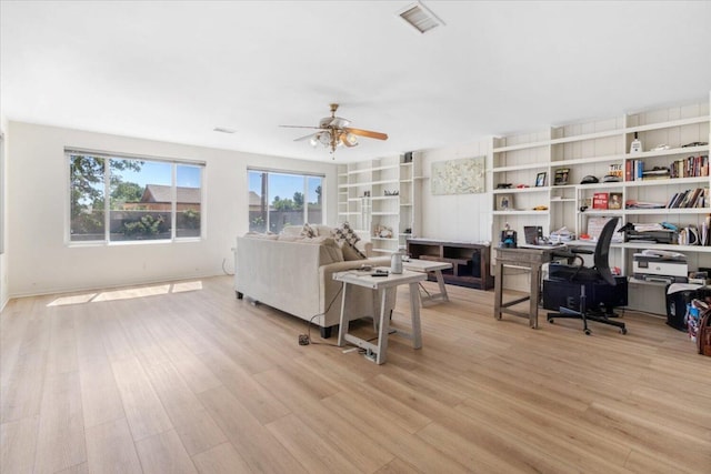 living room with ceiling fan and light hardwood / wood-style floors