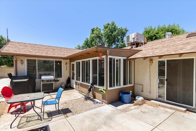 back of property with a patio