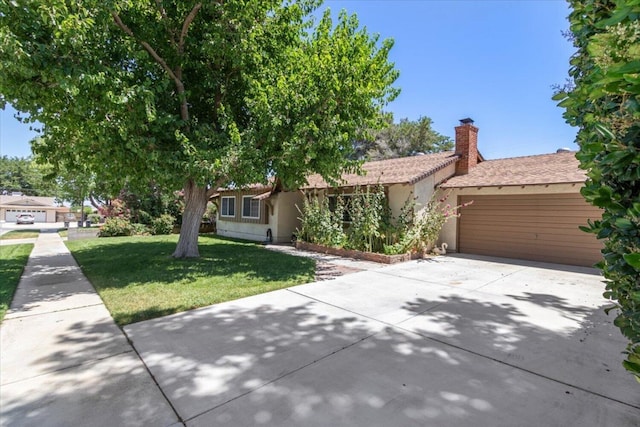 view of front of house with a garage and a front lawn