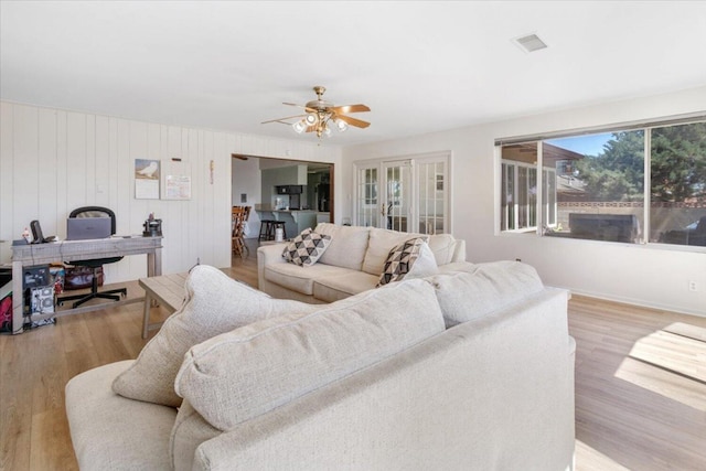 living room featuring ceiling fan and light wood-type flooring