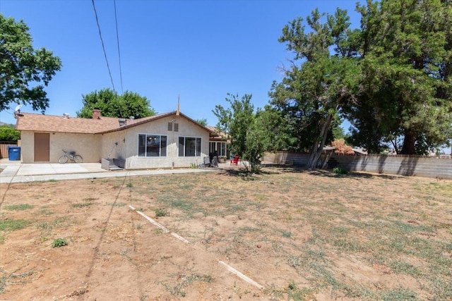 back of property with a patio