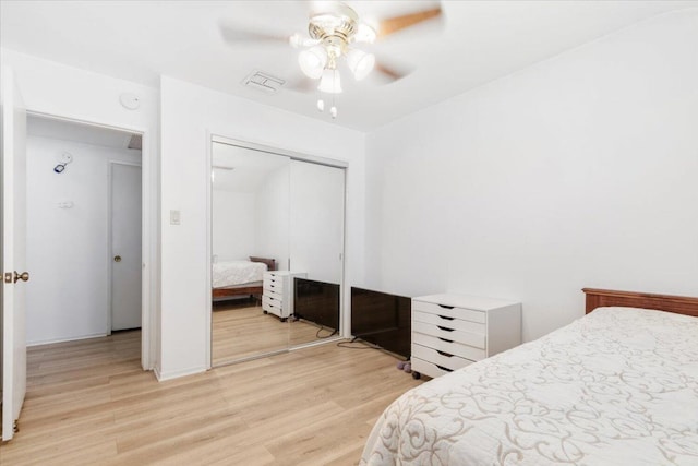 bedroom with a closet, ceiling fan, and light hardwood / wood-style flooring