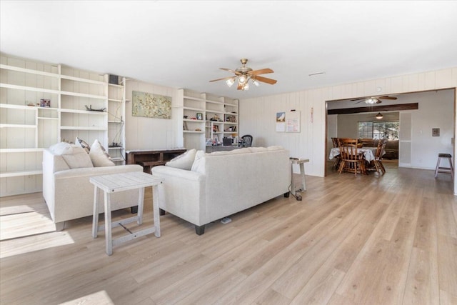 living room with ceiling fan and light hardwood / wood-style flooring