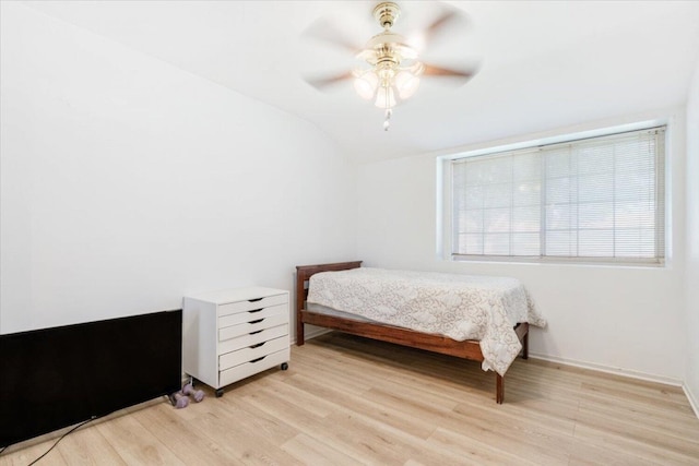 bedroom featuring ceiling fan, vaulted ceiling, and light hardwood / wood-style floors