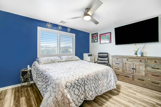 bedroom with light wood-type flooring and ceiling fan