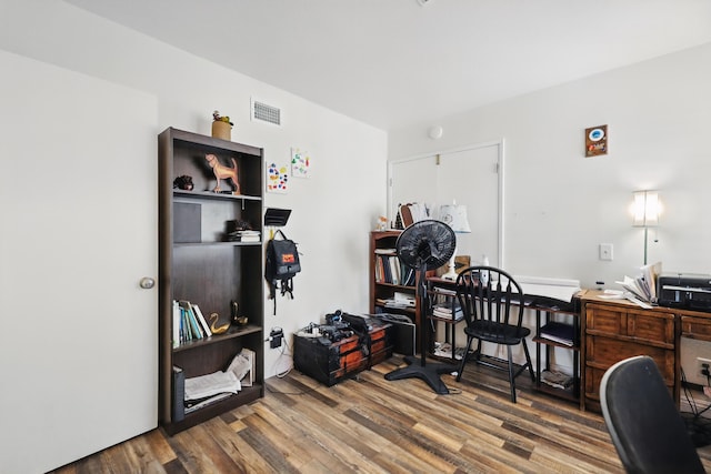 office featuring visible vents and wood finished floors