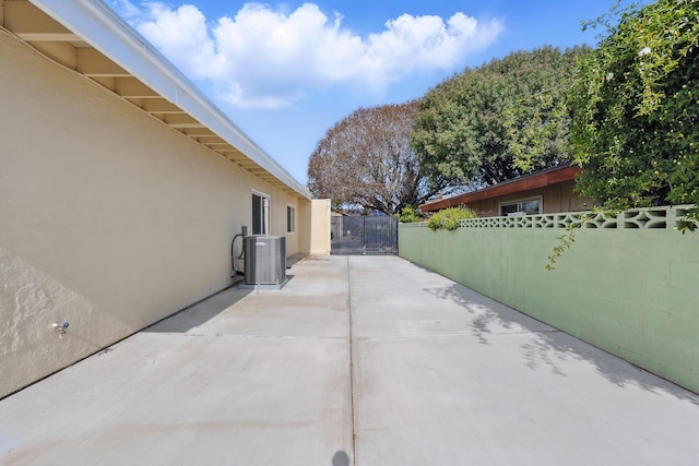 view of patio featuring central AC and fence