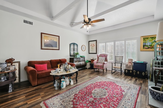 living room featuring a ceiling fan, visible vents, beam ceiling, wood finished floors, and baseboards