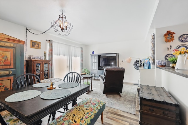dining room featuring light wood-type flooring and a chandelier
