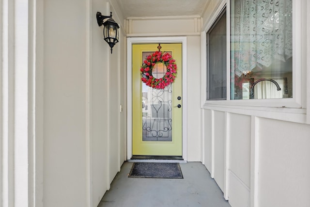 property entrance featuring board and batten siding