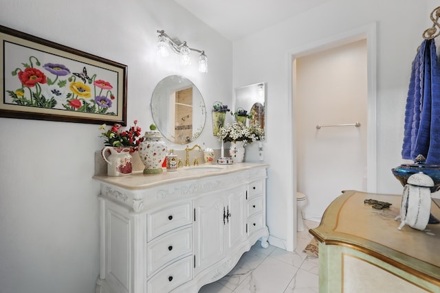bathroom featuring vanity, toilet, and marble finish floor