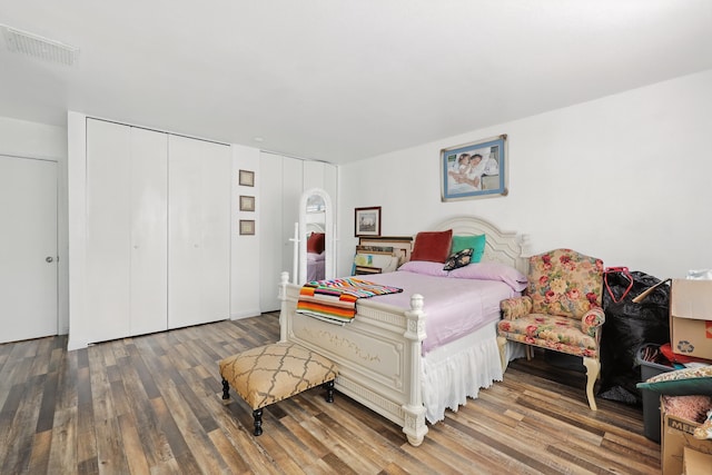bedroom with visible vents and wood finished floors