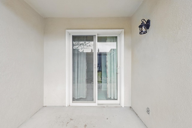 doorway to property with stucco siding